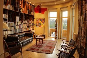 a living room with a couch and bookshelves at High End Budapest in the city center in Budapest