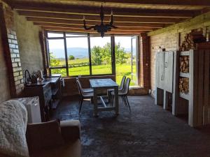 a kitchen with a table and chairs and a large window at Vasanna in Kosiv