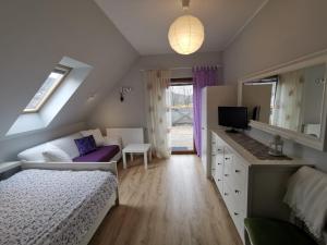 シフィエラドゥフ・ズドルイにあるStrefa Ciszy -Lawendaのベッドルーム1室(ベッド1台付)、リビングルームが備わります。