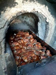 a group of chickens cooking in a brick oven at Старата дюля in Avren