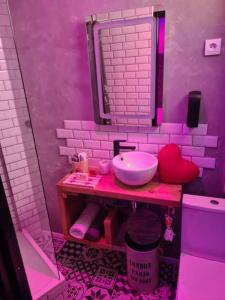 a pink bathroom with a sink and a mirror at Cocoon d'Allauch in Allauch