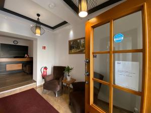 a waiting room with a door and a piano at Hotel Fluss Oase - Feldschlößchen in Weißenfels