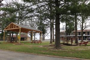 a picnic area with benches and a pavilion in a park at Ranch Motel in Salem