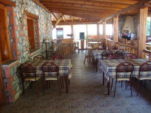 a restaurant with tables and chairs in a room at Farma in Taxiarchis