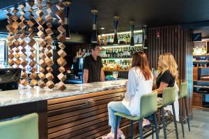 pessoas sentadas num bar num restaurante em The Earl in Charlevoix em Charlevoix