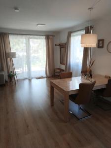 a living room with a wooden table and a table and chairs at Urlaub mitten in Markelsheim in Bad Mergentheim