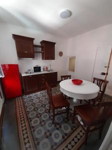 a kitchen with a table and chairs and a kitchen with a refrigerator at Angilina's apartment in Vernazza
