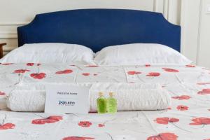 a bed with two towels and two bottles on it at Superb flat two steps away from Porte Maillot in Paris - Welkeys in Paris