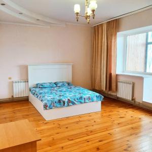 a bedroom with a bed and a wooden floor at Apartments of 4 S.K.D in Sumy