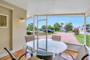 a dining room with a glass table and chairs at Comfy 3 bedroom with parking & close to everything in Naples