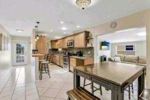 a large kitchen with a table in a room at Comfy 3 bedroom with parking & close to everything in Naples