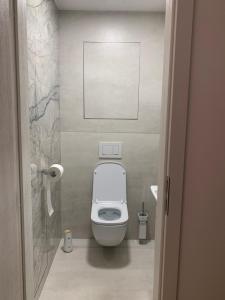 a bathroom with a toilet in a small room at ARMERIA 4/1 in Štrbské Pleso +22 photos