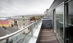a balcony with a view of a city at 62N Hotel - City Center in Tórshavn