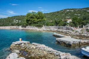 a boat is docked in a body of water at House Tvrdica in Tkon