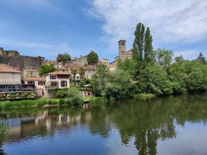 a view of a river with a town in the background at Centre historique de Clisson avec Spa Intérieur in Clisson