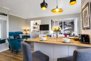 a kitchen with a counter with chairs and a table at Flat with terrace and incredible view in Biarritz - Welkeys in Biarritz