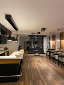 a large kitchen and living room with wooden floors at Hotel Fluss Oase - Feldschlößchen in Weißenfels