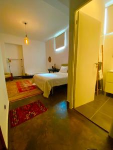 a bedroom with a bed and a door to a room at 1955 Guest House in Cebolais de Cima