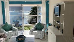 a living room with a view of the ocean at Paradise On the Bay in Fish hoek