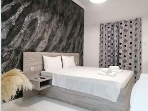 a bedroom with a large bed with a large painting on the wall at Jz Plus e'Bella in Rhodes Town