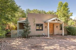 a small house with a door and a fence at Casa Buena Suerte- Near Plaza- Quiet- Patio- 2 BR in Santa Fe