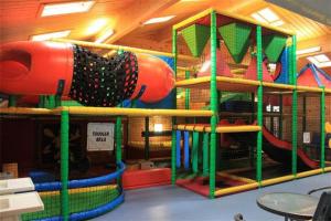 a play room with a playground with a slide at Perfect for the family and beaches - Gower Cwtch in Swansea