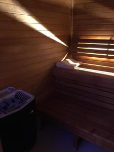 a sauna with a bench and a window in it at Aux 5 Sens in Tillé
