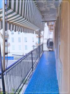 a balcony of a building with a swimming pool at La casa di Palma in Alassio