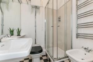 a bathroom with a sink and a toilet and a shower at Radio Apartments London - Covent Garden in London