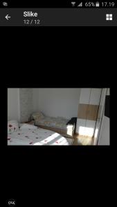 a picture of a bedroom with two beds in a room at Apartman Rada 2 in Bijeljina