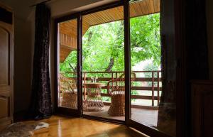 a room with doors open to a balcony with trees at Villa Townhouse 36 Sibiu in Sibiu +11 photos