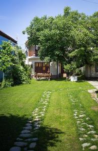 a garden with a tree and a stone path at Villa Townhouse 36 Sibiu in Sibiu