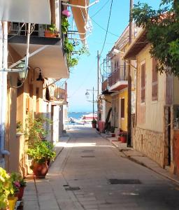 an empty street with buildings and the ocean in the background at Hellenes house in Lefkada