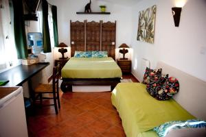 a bedroom with two beds and a couch in it at Cortijo Flamingos in Chiclana de la Frontera +64 photos