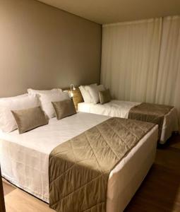 Postel nebo postele na pokoji v ubytování Laghetto Resort Golden Gramado