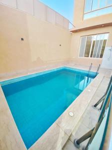 a swimming pool in a house at شاليه العبير in Buraydah
