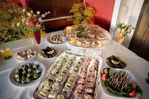 a table with many different types of food on it at Ciftlik Hotel in Çeşme