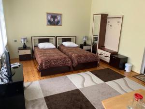 a bedroom with a bed and a large mirror at Sheki Avtovagzal Motel in Sheki