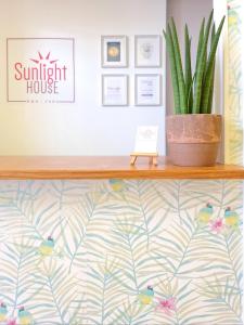 
a wall with a picture of a plant on it at Sunlight House in Faro
