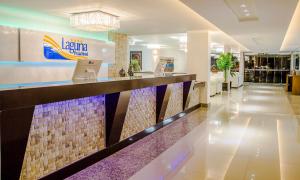 a lobby of a hotel with a reception counter at Laguna Praia Hotel in João Pessoa