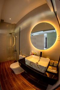 a bathroom with a large sink and a mirror at The Dreamers Homestay in Hue