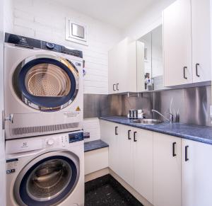 a kitchen with a washing machine and a sink at Snow Ski Apartments 20 in Falls Creek