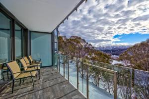 a balcony with chairs and a view of the mountains at Snow Ski Apartments 20 in Falls Creek