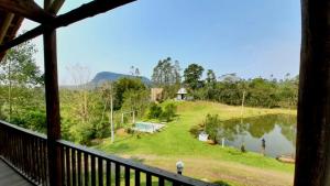 a view from the porch of a house with a lake at Pouso das Águias in Nova Veneza +21 photos