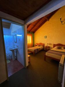 a room with two beds and a sink in it at Bla Lodge in El Calafate