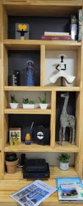 a wooden book shelf with items on it at Apezinho.Loft in Rio de Janeiro