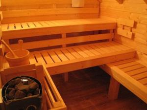 a wooden sauna with a bench in a room at Magnificent wooden chalet with sauna in Ventron