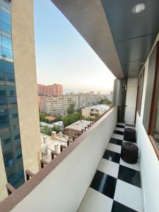 einen Balkon mit Schachbrettboden in der Unterkunft Cascade - Opera Apartment in Yerevan