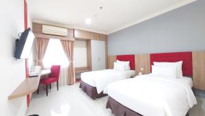 Kama o mga kama sa kuwarto sa Moritz Hotel RSAB Harapan Kita