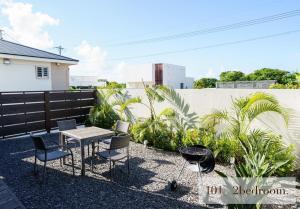 a patio with a table and chairs and a grill at HOTEL FIT IN ISHIGAKIJIMA 新築2021年4月OPEN セキュリティ万全 セルフチェックイン -SEVEN Hotels and Resorts- in Ishigaki Island